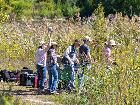 RIT students and researchers collecting data in the wetlands area of Tait Preserve as part of ROCX 2025.