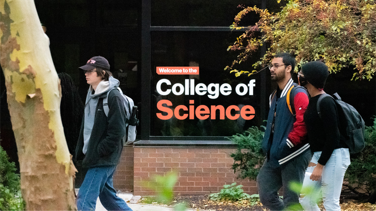 students walking by the College of Science building