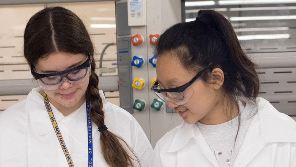 High school students doing experiments in a lab at R I T as part of SMASH.