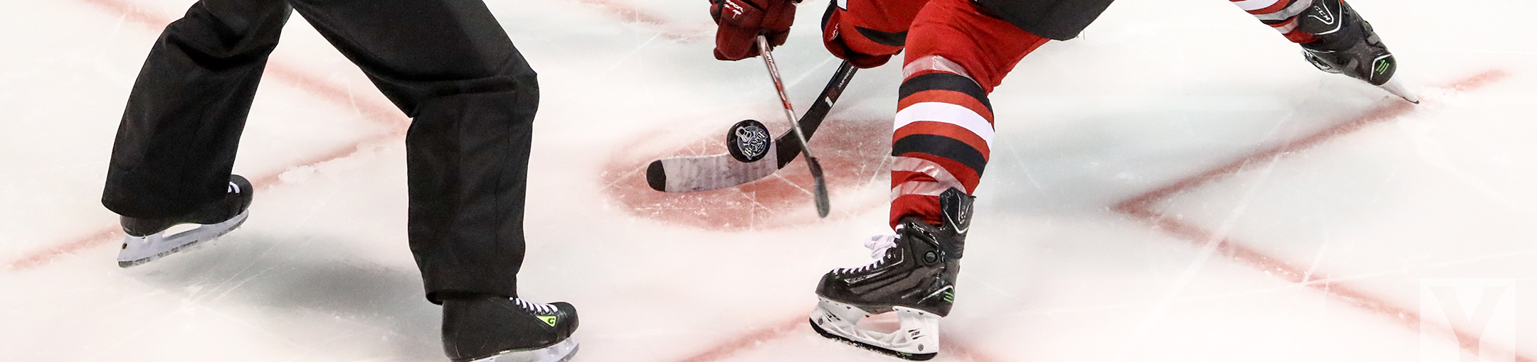 ice hockey players facing off