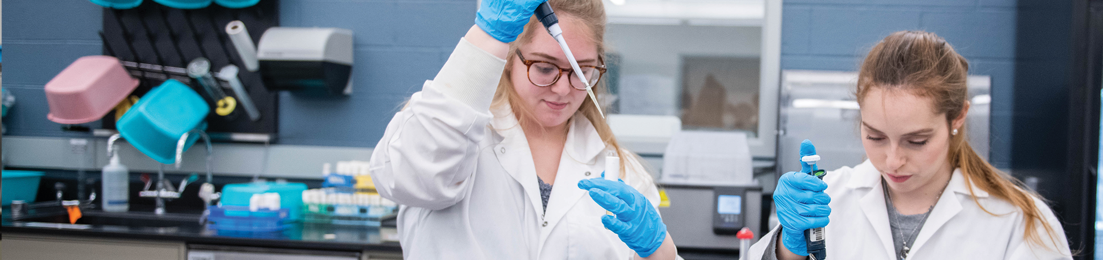 two female students working in a biology lab