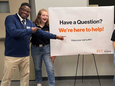 Dean Hudson standing with a student during Open House