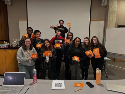 students holding up cards that they have written