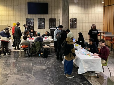 students gathering around tables for the Frosted Club Fext