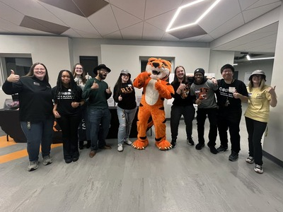 Ritchie standing with a group of students at Open House