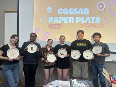 group of students holding paper plate awards