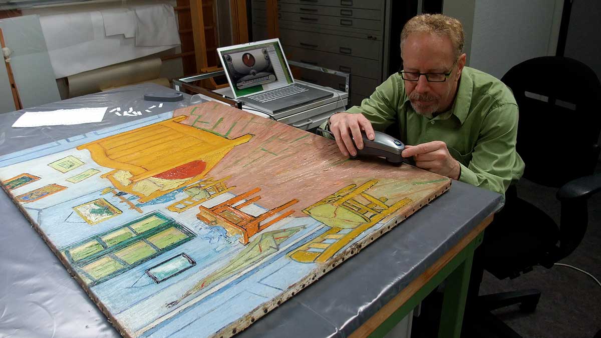 professor examining a painting
