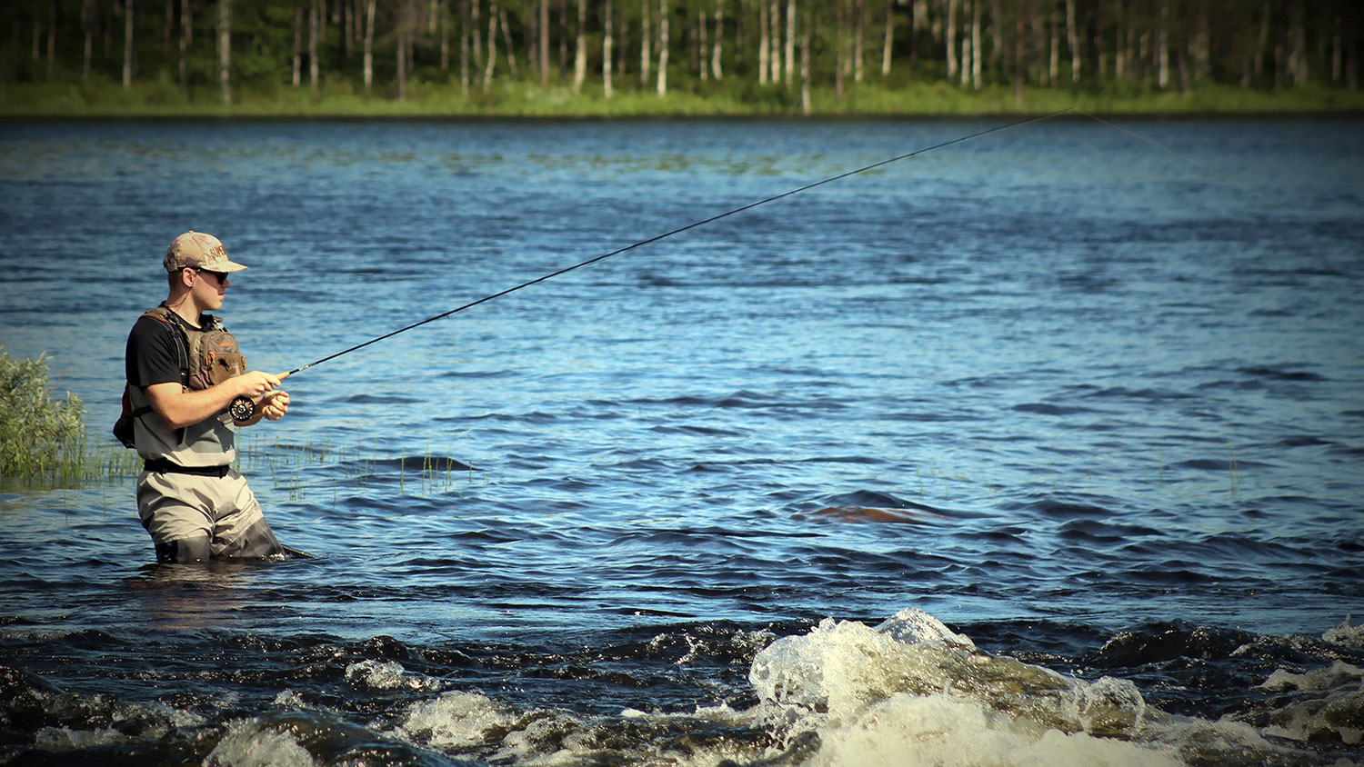 man fishing in lake
