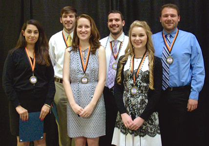 group shot of students wearing medallions