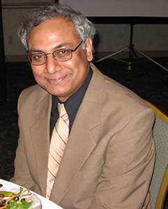 Professor Balakrishnan sitting at a table