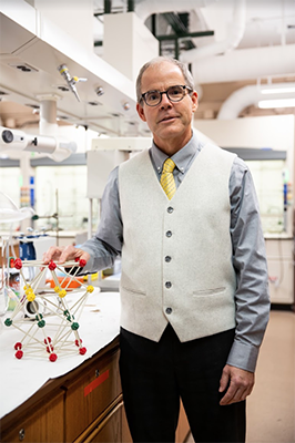 male professor standing in chemistry lab