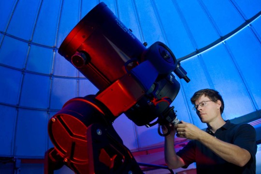 Person calibrating a telescope
