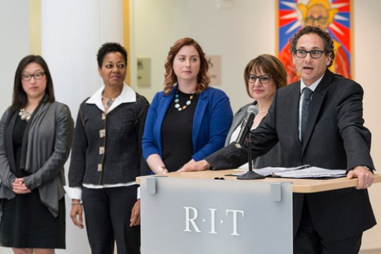 People accepting awards on stage in gallery