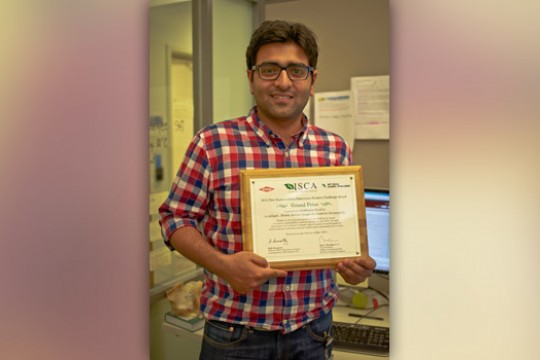 Person posing with award