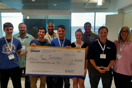 People posing with giant check