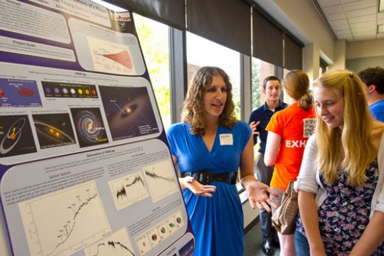 People discussing poster at event
