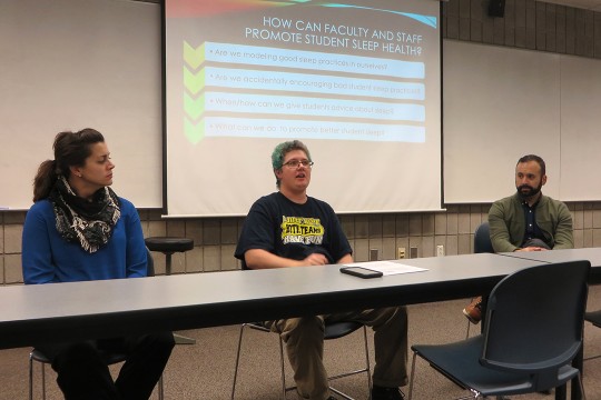 three panelists sitting at a table
