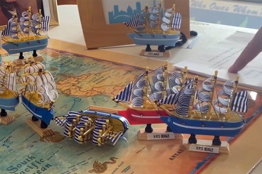 a map of the world with model boats on it.