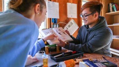 Two students looking at a textbook.
