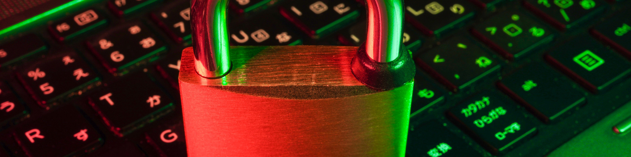 A laptop with a padlock resting on the keyboard.