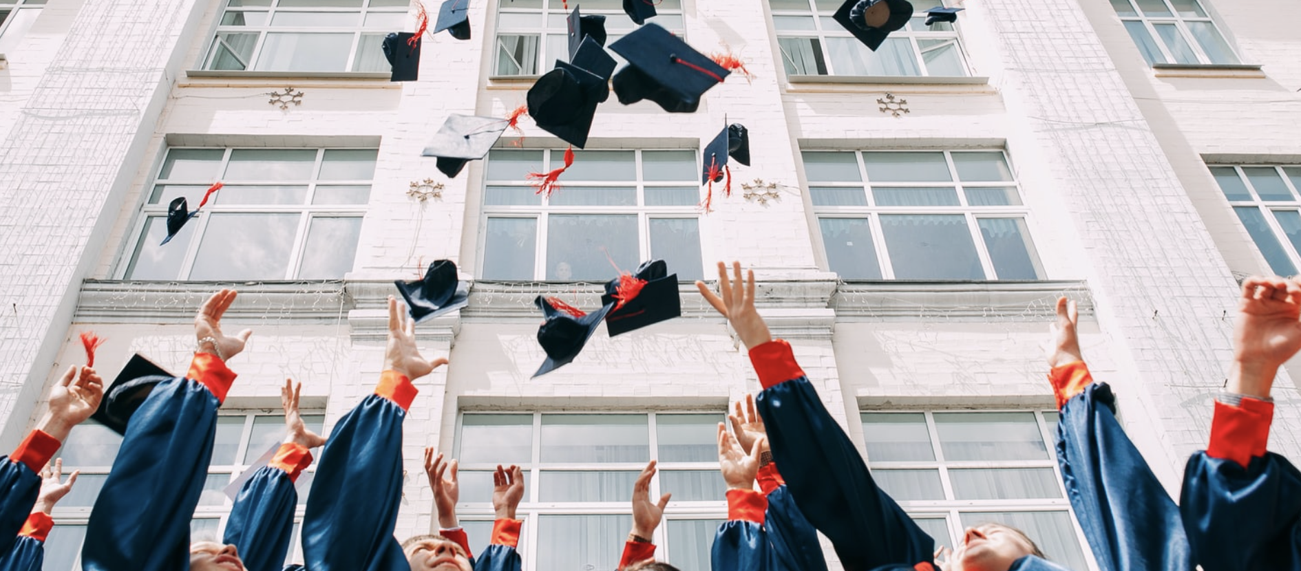 group of fresh graduates students throwing their academic hat in the air photo 