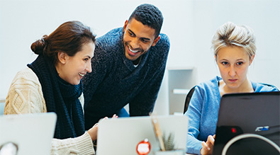Group of students working together around their computers