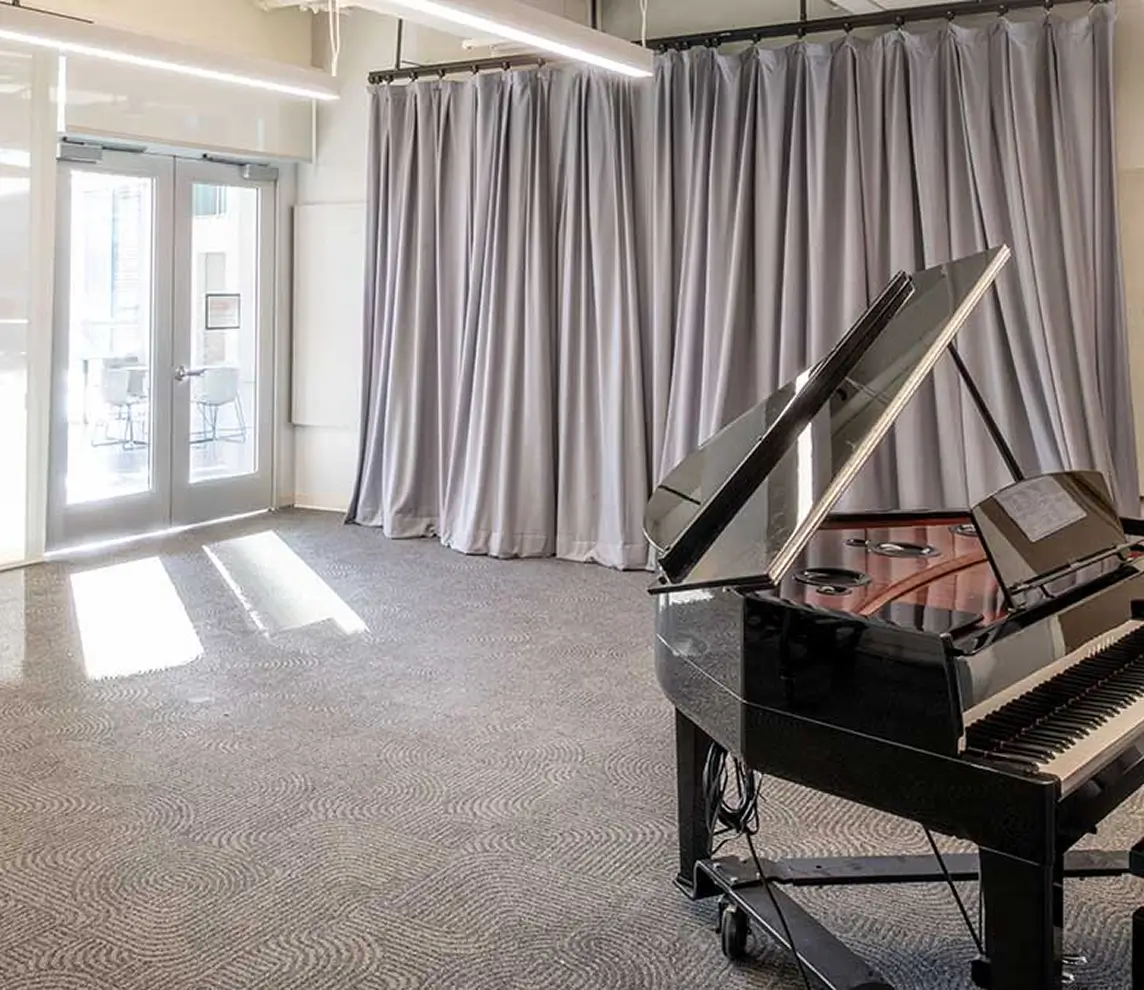 A piano sitting in the Ensemble Studio, in the SHED.