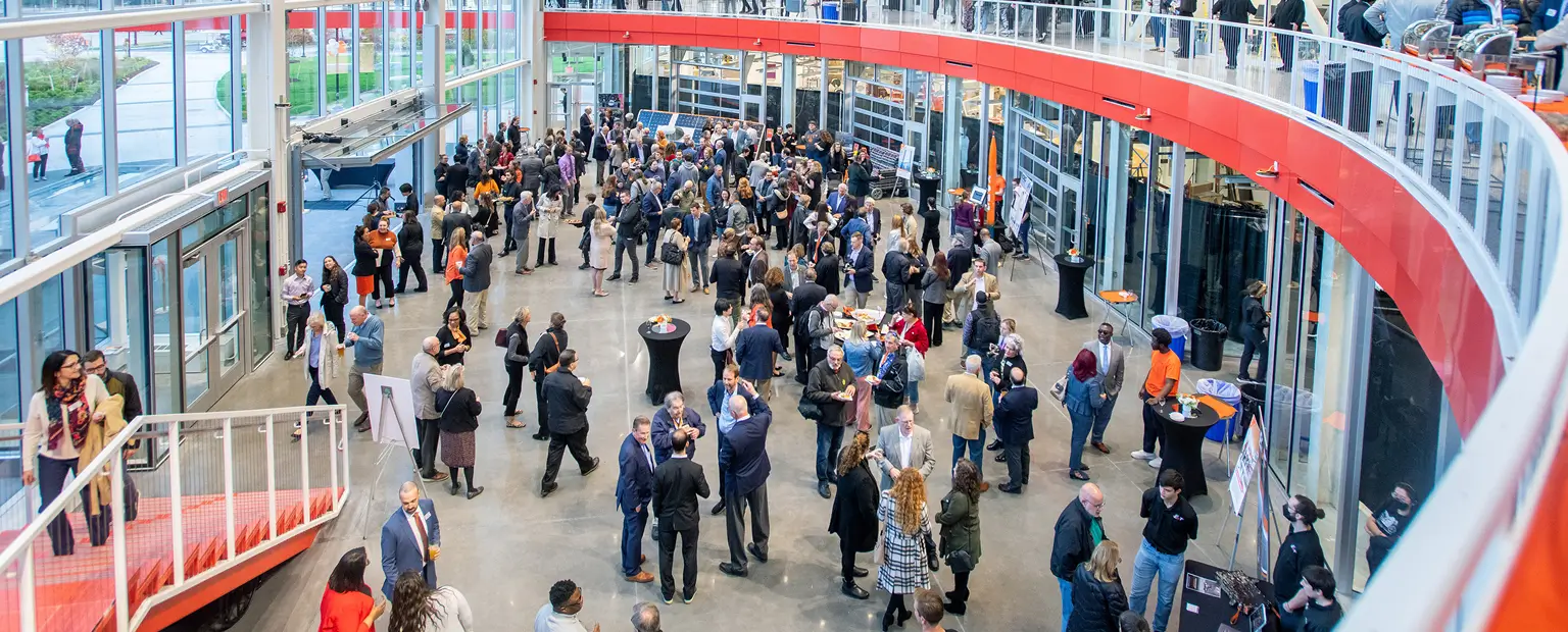 A large group of people gathered in the atrium of the SHED.