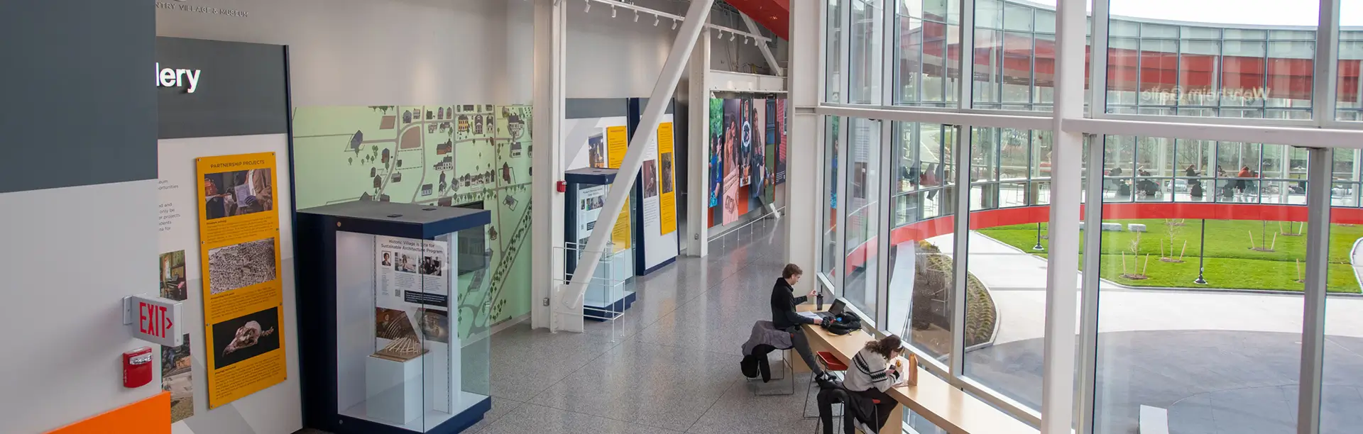 Two students sit at a table in the Wehrheim Gallery section of the SHED.