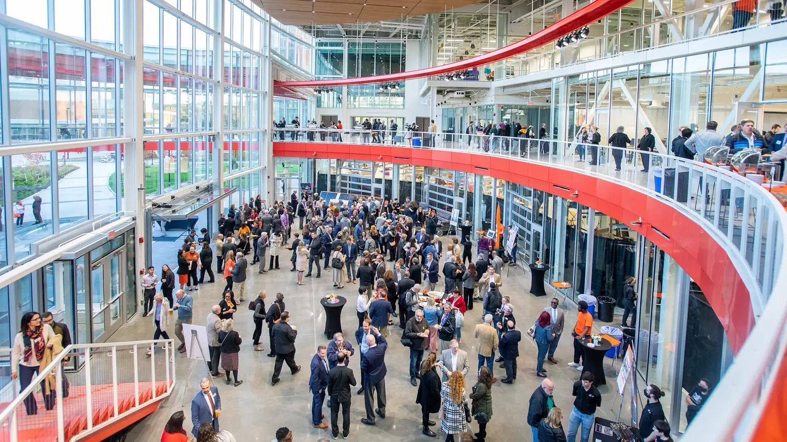 A large group of people gathered for an event in the atrium of the SHED.