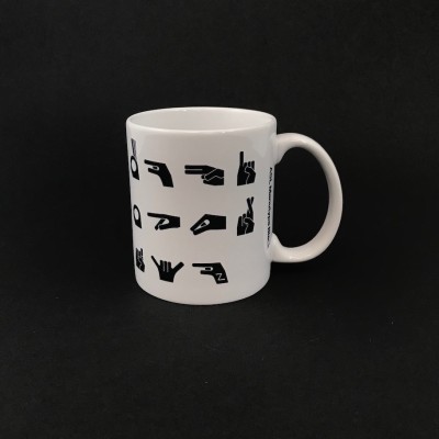 Coffee mug with graphic representations of American Sign Language letter signs.
