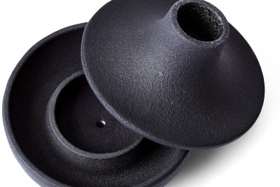 black cast iron two sectioned Candle Holder with top resting on bowl shaped bottom.