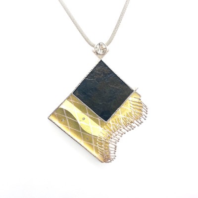 sculptural pendant on braided silver chain.