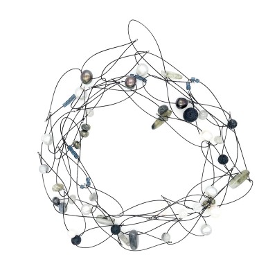 a variety of faceted beads, shells, naturally tumbled glass, and semi precious stones on a black coated wire necklace.