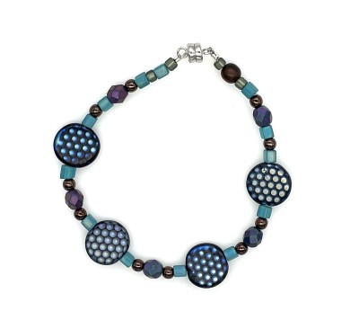 Bracelet made of a variety of glass and stone beads, with four large dot patterned beads.