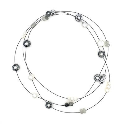 a necklace of a long thin cable that is strung randomly with beads in variety of shape and color and materials from clay to white pearls to faceted glass.