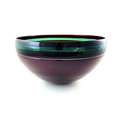 a glass bowl with a smooth surface and dark purple base, black band around the rim with a bright green accent stripe.