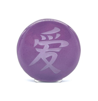 a round purple glass disc with a sandblasted Chinese characture 'Love'.