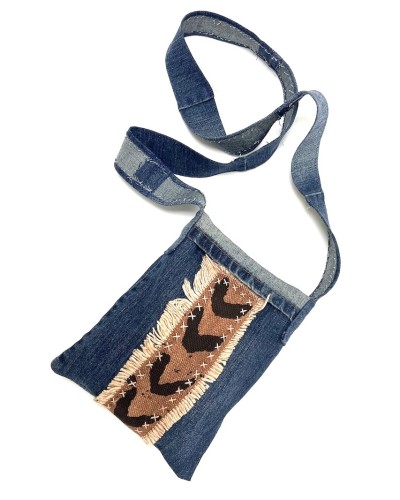 a handsewn blue jean fabric shoulder bag with strips of brown and black chevron patterned African mudcloth..