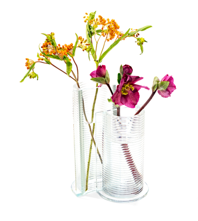 two clear glass vases with a ribbed textural round half and a flat side.