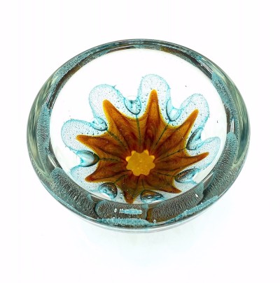 a round clear glass bowl with a starfish like gold design in the center with air bubbles around it.