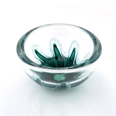 a round clear glass bowl with a starfish like green design in the center with air bubbles around it.