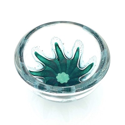a round clear glass bowl with a starfish like green design in the center with air bubbles around it.