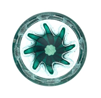 a round clear glass bowl with a starfish like green design in the center with air bubbles around it.