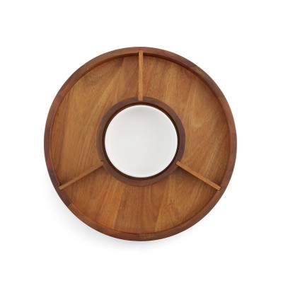 a round wood lazy susan with three compartments and a white porcelain dish in the center.