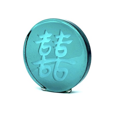 a round green glass disc with the Chinese character 'Double Joy, Double Happiness'.