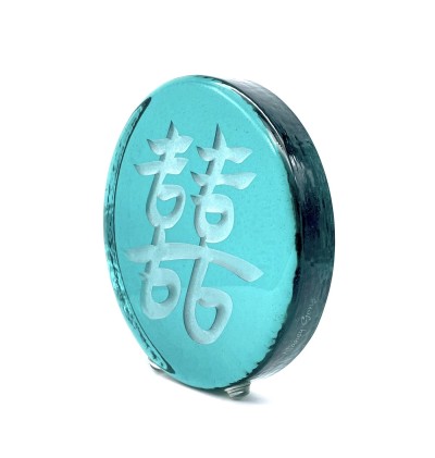 a round green glass disc with the Chinese character 'Double Joy, Double Happiness'.