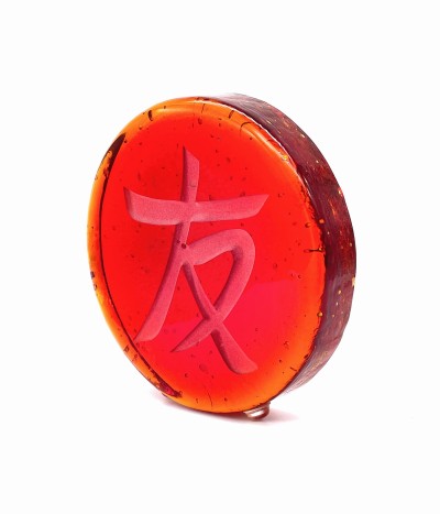 a red round glass disc with the Chinese character 'Friend, Friendship'.