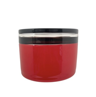 a hand blown glass vessel with a deep cherry-hued base and accentuated with a black and clear glass band at the top edge.