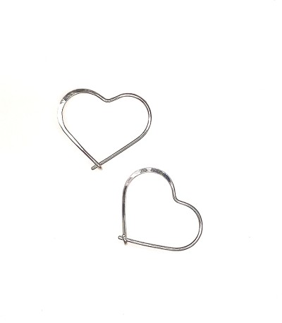 a handcrafted pair of Sterling silver heart shaped hoop earrings with a subtle hammered surface.